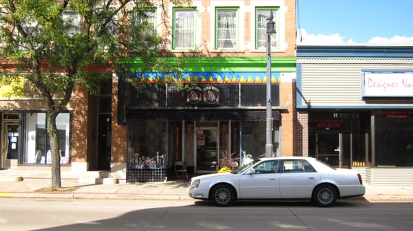 A white car parked on the side of a street.