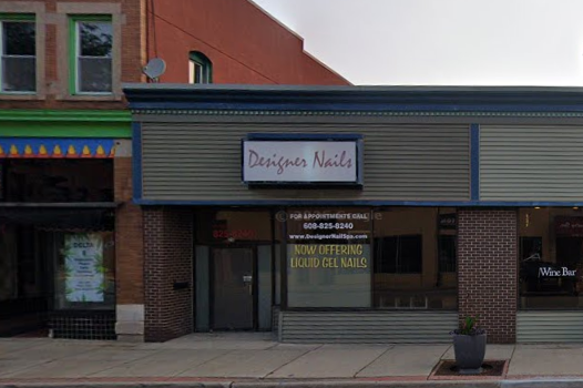 A store front with signs on the windows.