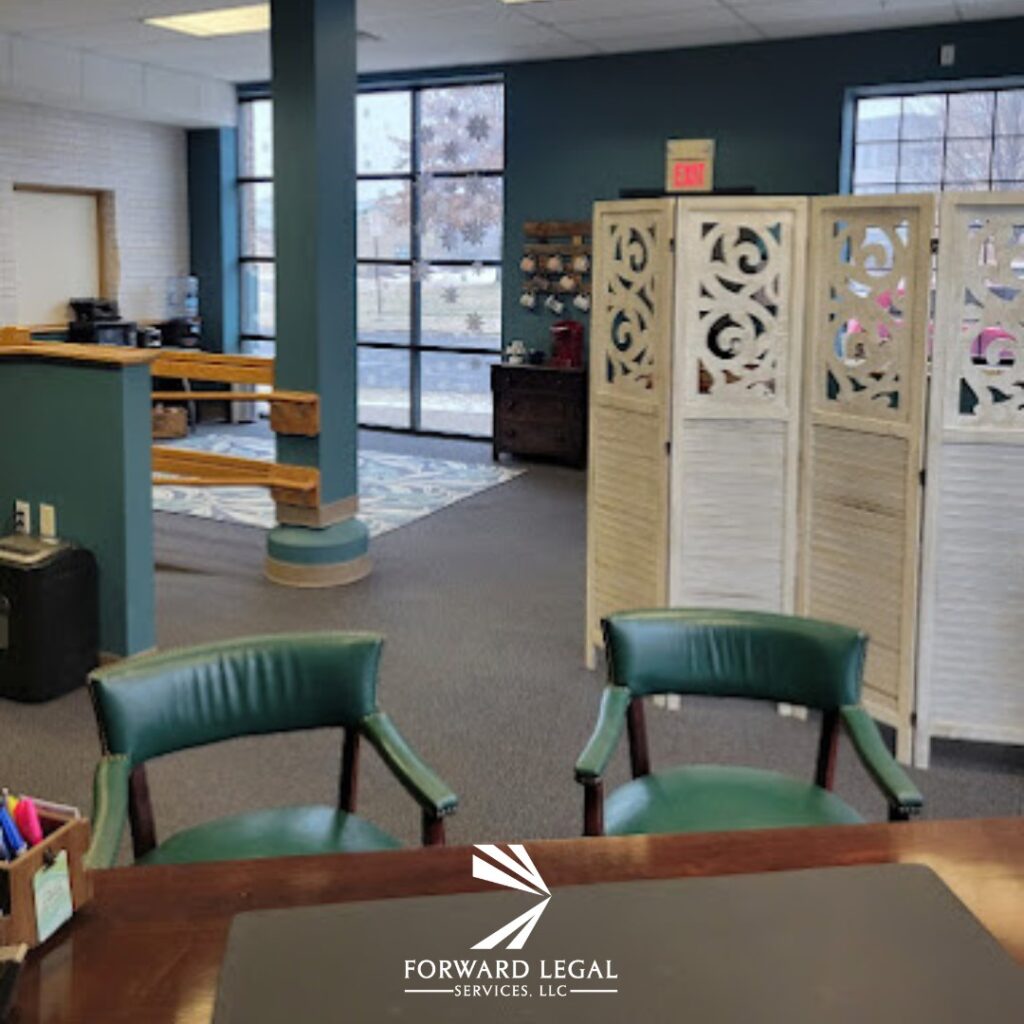 Office lobby with green chairs, a wooden desk, a decorative privacy screen, large windows, and the Forward Legal Services, LLC logo at the bottom center.